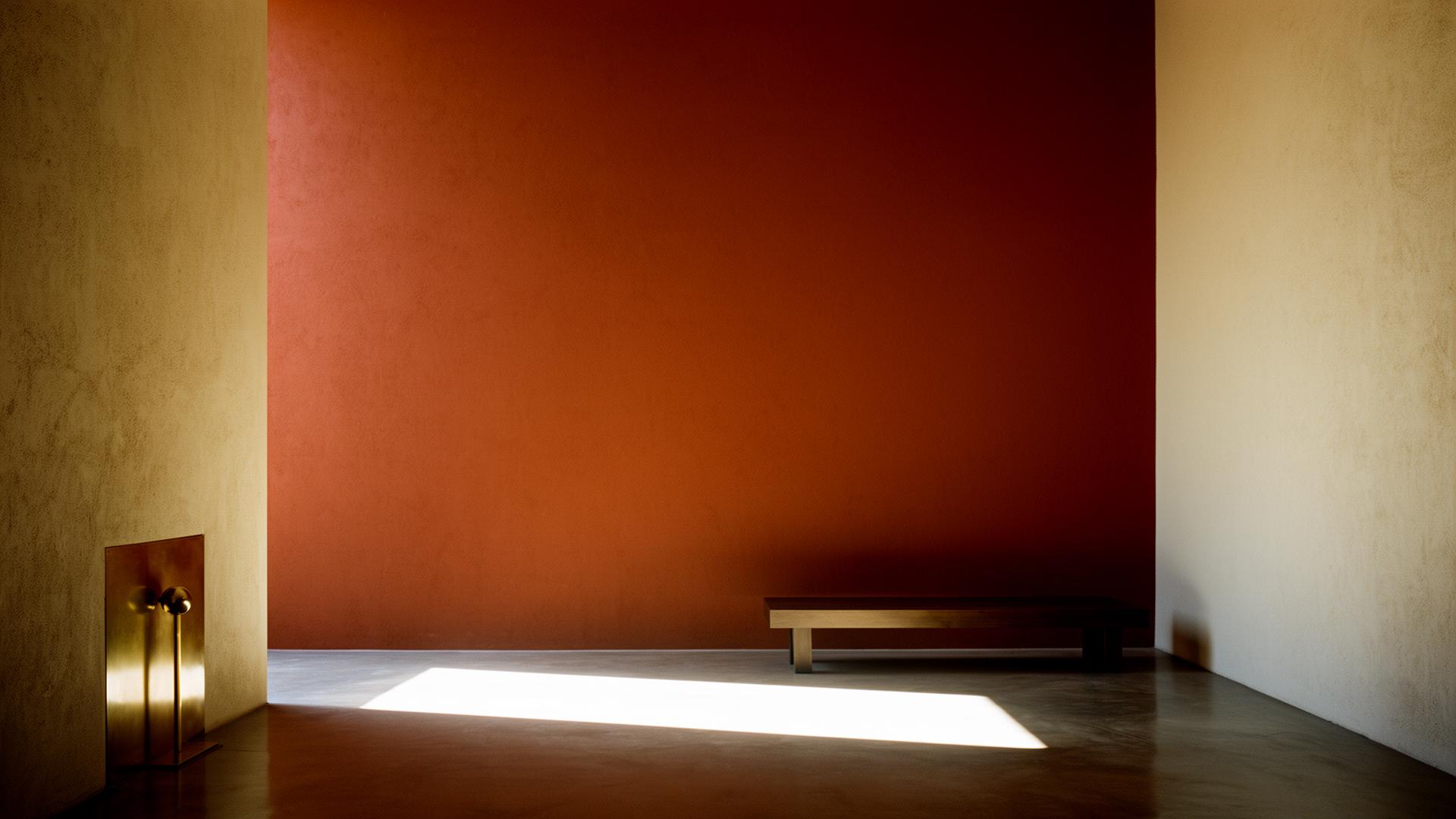 Architectural interior in Mexico City — rust wall with shaft of light